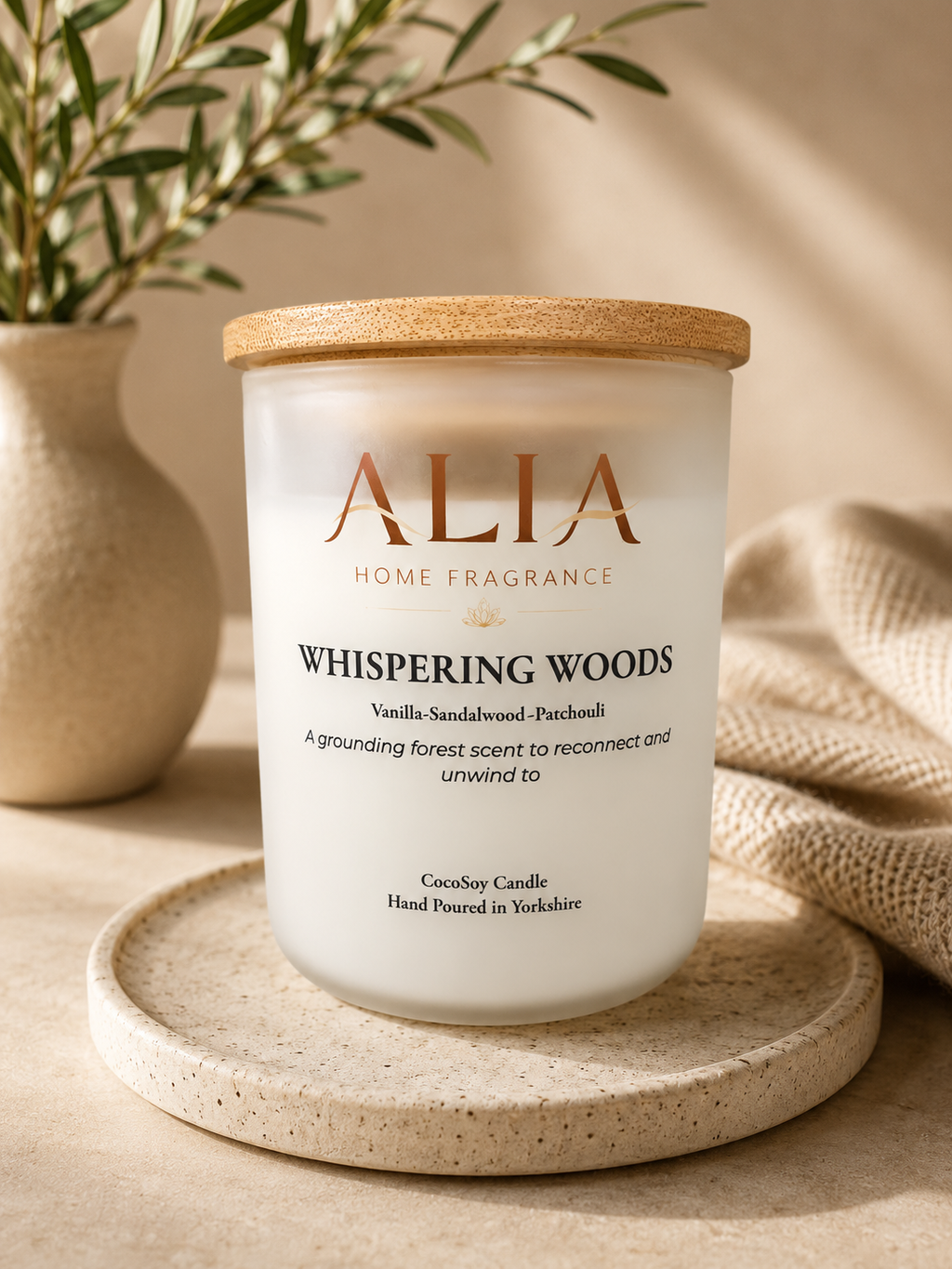 A Vanilla and Sandalwood fragranced cocosoy candle in a frosted glass jar with bamboo lid