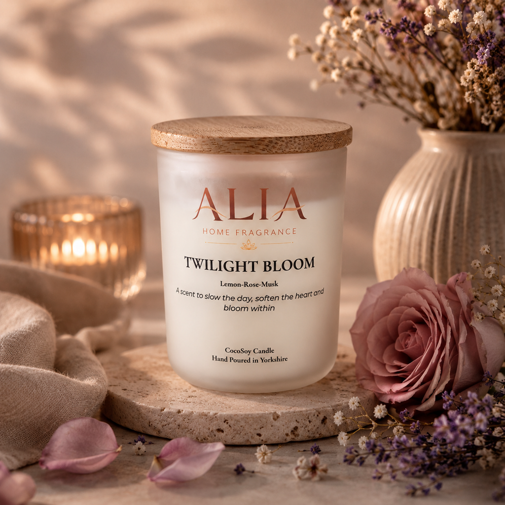 A floral scented cocosoy candle in a frosted glass jar with bamboo lid